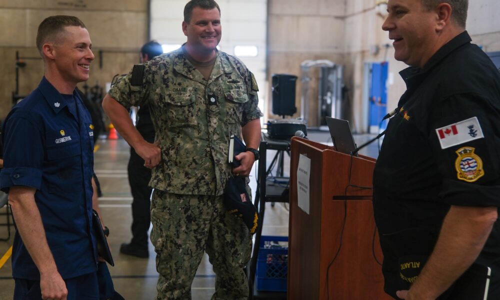 U.S. Coast Guard Cmdr. Brian Gismervik, commanding officer of Coast Guard Cutter Northland (WMEC 904), U.S. Navy Cmdr. Jeremiah Chase, commanding officer of Arleigh Burke-class guided-missile destroyer USS Delbert D. Black (DDG 119) and Royal Canadian navy Capt. Gord Noseworthy, commander of Task Group 300.10, talk at a pre-sail conference for Operation Nanook, Aug. 12, 2024, in Halifax, Nova Scotia.