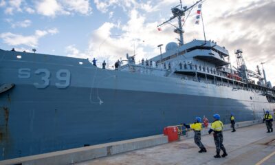 Military Sealift Command civil service mariners assigned to the submarine tender USS Emory S. Land (AS 39) throw a heaving line from the ship to Royal Australian Navy sailors on the pier as the Emory S. Land moors at HMAS Stirling, Western Australia, Australia, Aug. 16.