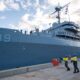 Military Sealift Command civil service mariners assigned to the submarine tender USS Emory S. Land (AS 39) throw a heaving line from the ship to Royal Australian Navy sailors on the pier as the Emory S. Land moors at HMAS Stirling, Western Australia, Australia, Aug. 16.