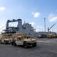 Military vehicles are staged near Military Sealift Command chartered ship MV Cape Hudson (T-AKR 5066) during an offload of equipment in support of exercise Super Garuda Shield 2024, at the Port of Banyuwangi, Indonesia Aug. 12. Super Garuda Shield, one of the largest multinational exercises in the Indo-Pacific region, continues to solidify the U.S.-Indonesia Major Defense Partnership Defense Cooperation Agreement and advances cooperation in support of a free and open Indo-Pacific region. (Navy photo by Grady T. Fontana)