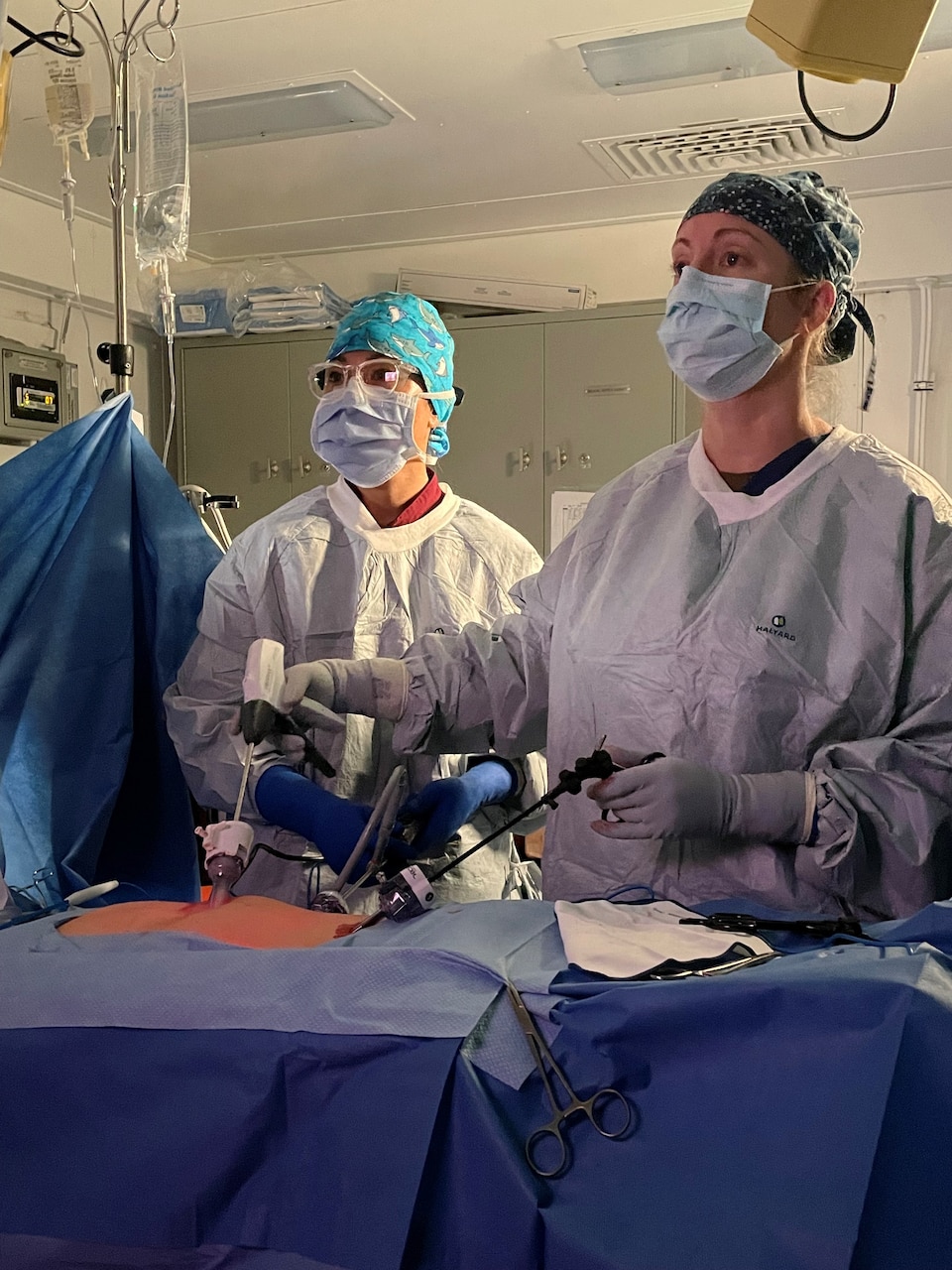 PACIFIC OCEAN (Aug. 9, 2024) Cmdr. Debra Lowry, middle, surgeon aboard Nimitz-class aircraft carrier USS Carl Vinson (CVN 70), and Lt. j.g. Kimberly Graff, physician assistant aboard Vinson, perform an appendectomy while underway in the U.S. 3rd Fleet area of operations. As an integral part of U.S. Pacific Fleet, U.S. 3rd Fleet operates naval forces in the Indo-Pacific in addition to providing realistic and relevant training necessary to flawlessly execute our Navy’s timeless roles of sea control and power projection. U.S. 3rd Fleet works in close coordination with other numbered fleets to provide commanders with capable, ready forces to deploy forward and win in day-to-day competition, in crisis, and in conflict. (Courtesy Photo)