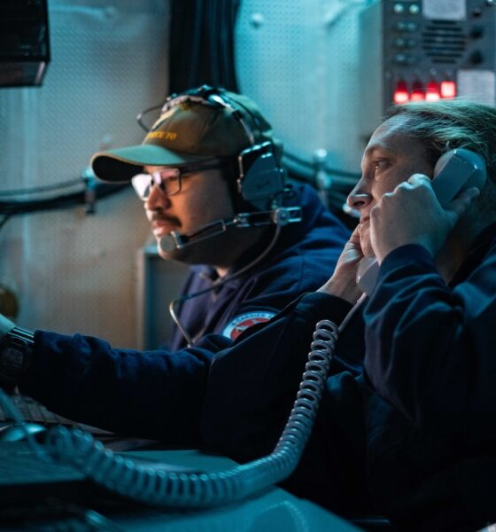 Cryptologic Technician (Technical) 1st Class Matthew Salazar, from Chicago, center, and Senior Chief Cryptologic Technician (Technical) Amy Woolston, from Jacksonville, North Carolina, both assigned to Commander, Task Force 70, embarked on U.S. 7th Fleet’s premiere forward-deployed aircraft carrier USS George Washington (CVN 73), maintain Carrier Strike Group 5 battlespace awareness while standing watch for the information warfare commander in the tactical flag command center while underway in the Pacific Ocean, during Keen Sword 25, Oct. 26.