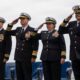 The official party salutes the national ensign aboard USS Makin Island (LHD 8) during a change of command ceremony at Naval Base San Diego.