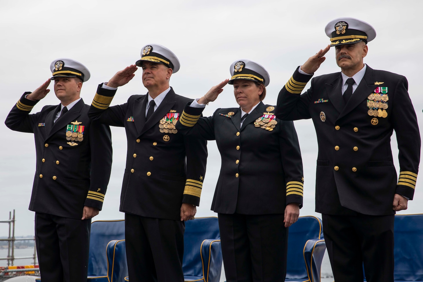 The official party salutes the national ensign aboard USS Makin Island (LHD 8) during a change of command ceremony at Naval Base San Diego.